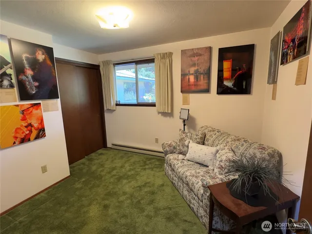 a living room with furniture and wall painting