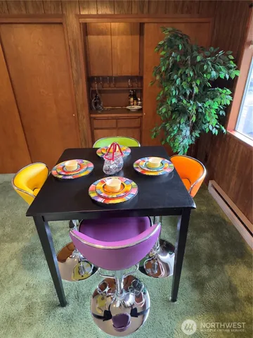 a dining room with furniture and wooden floor