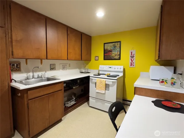 a utility room with sink dryer and washer