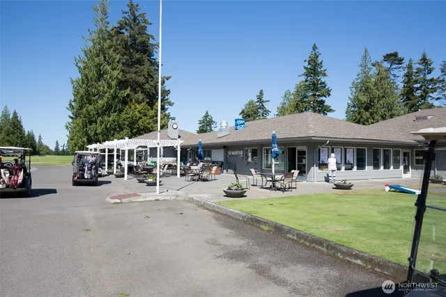 a view of a house with garden and sitting area