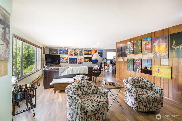 a living room with furniture and a floor to ceiling window