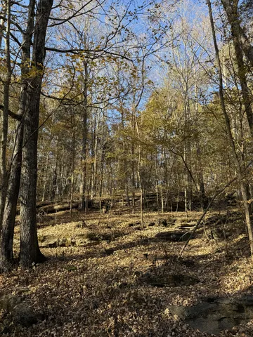 a small barn with a table and chairs in it