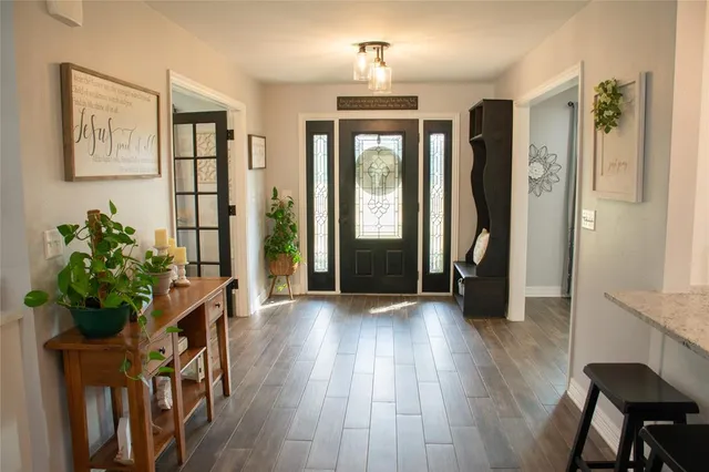 a view of hallway with wooden floor and stairs