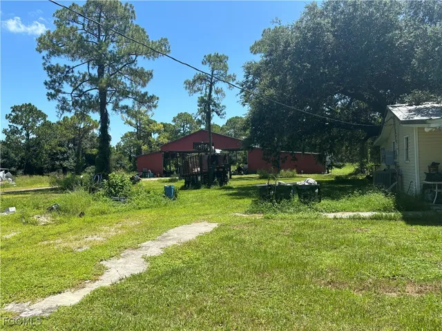 a view of a house with a yard patio and fire pit