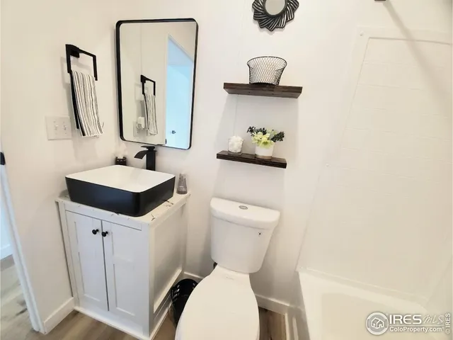 a white toilet sitting next to a bathroom sink
