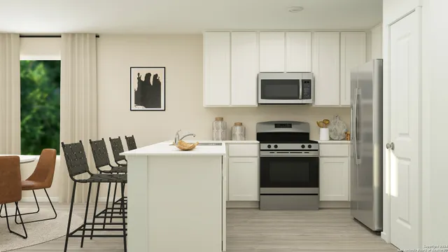 a kitchen with stainless steel appliances a stove a sink refrigerator and a microwave