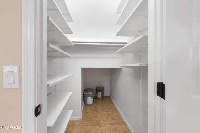 a view of a kitchen with a refrigerator and a stove top oven