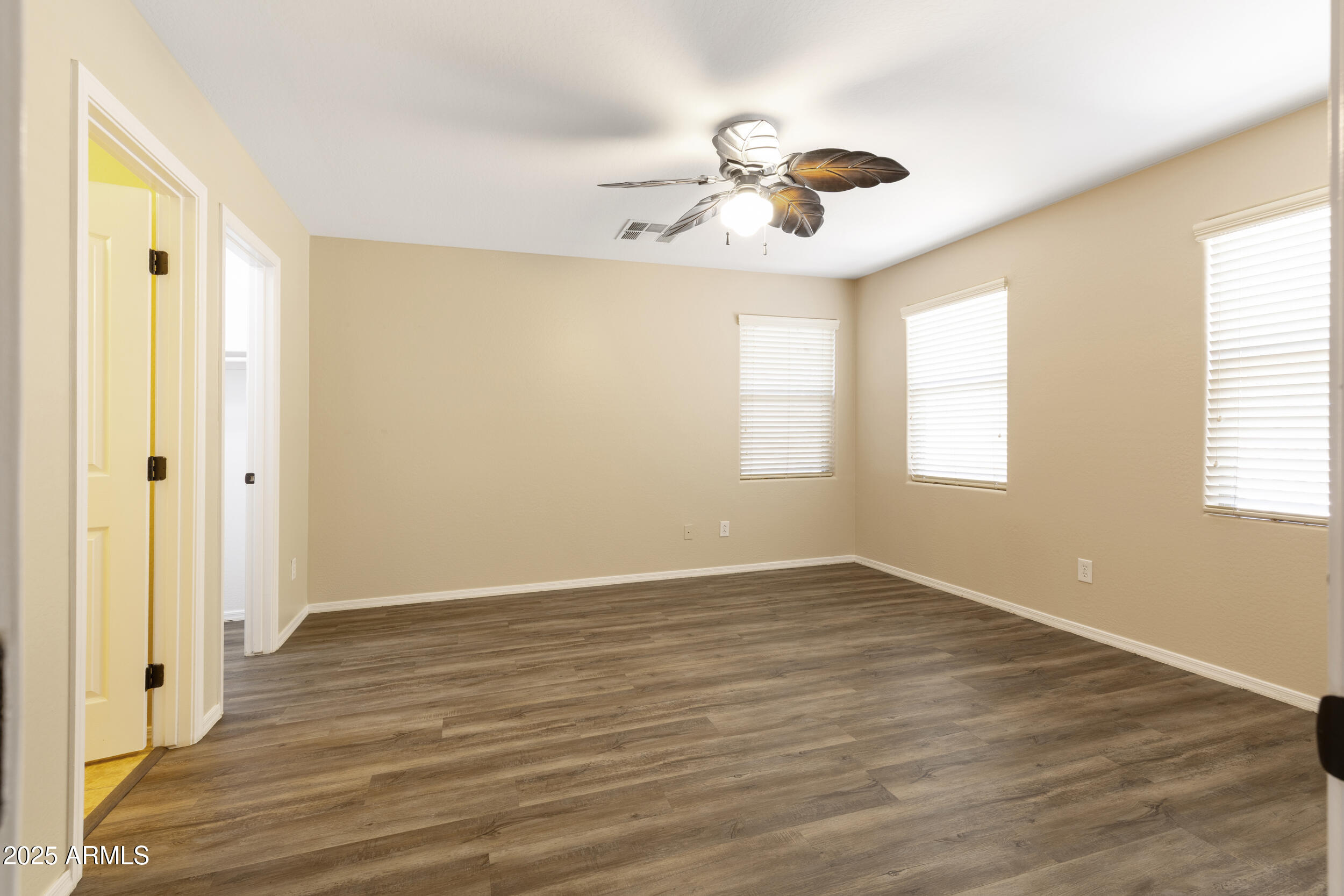 1870 South Colt Drive Gilbert, AZ 85295 - Photo 28 of 42 an empty room with wooden floor fan and windows