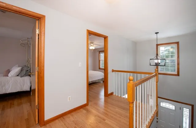 a view of a hallway with wooden floor and furniture