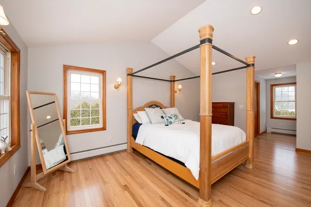 a bedroom with a bed and a large window