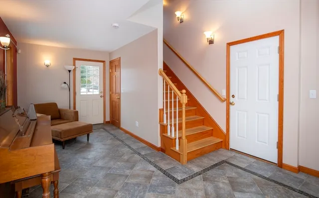 a view of a livingroom with furniture and staircase