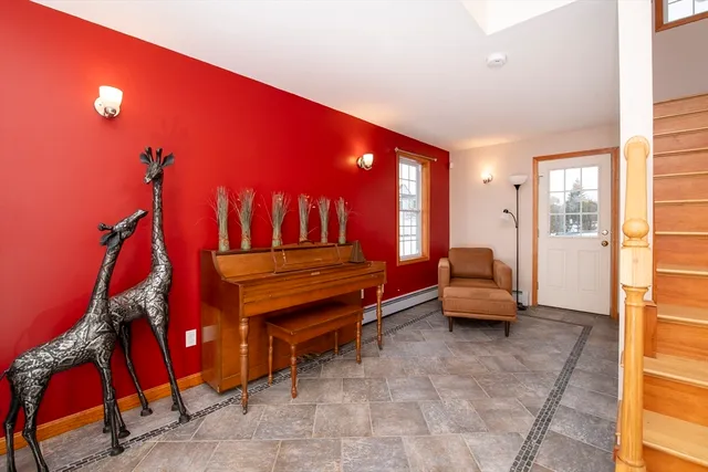 a living room with furniture a air conditioner vent and a window