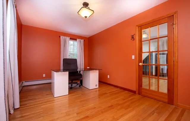 a view of a room with wooden floor washing machine and racks