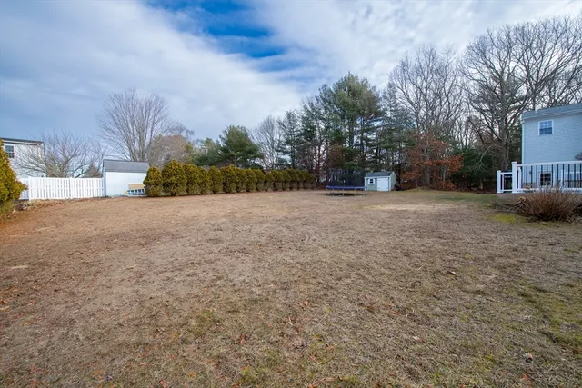 a view of a house with wooden deck front of house