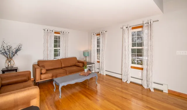 a living room with furniture and wooden floor