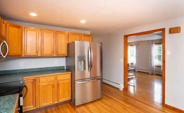 a kitchen with stainless steel appliances granite countertop a refrigerator and a stove top oven