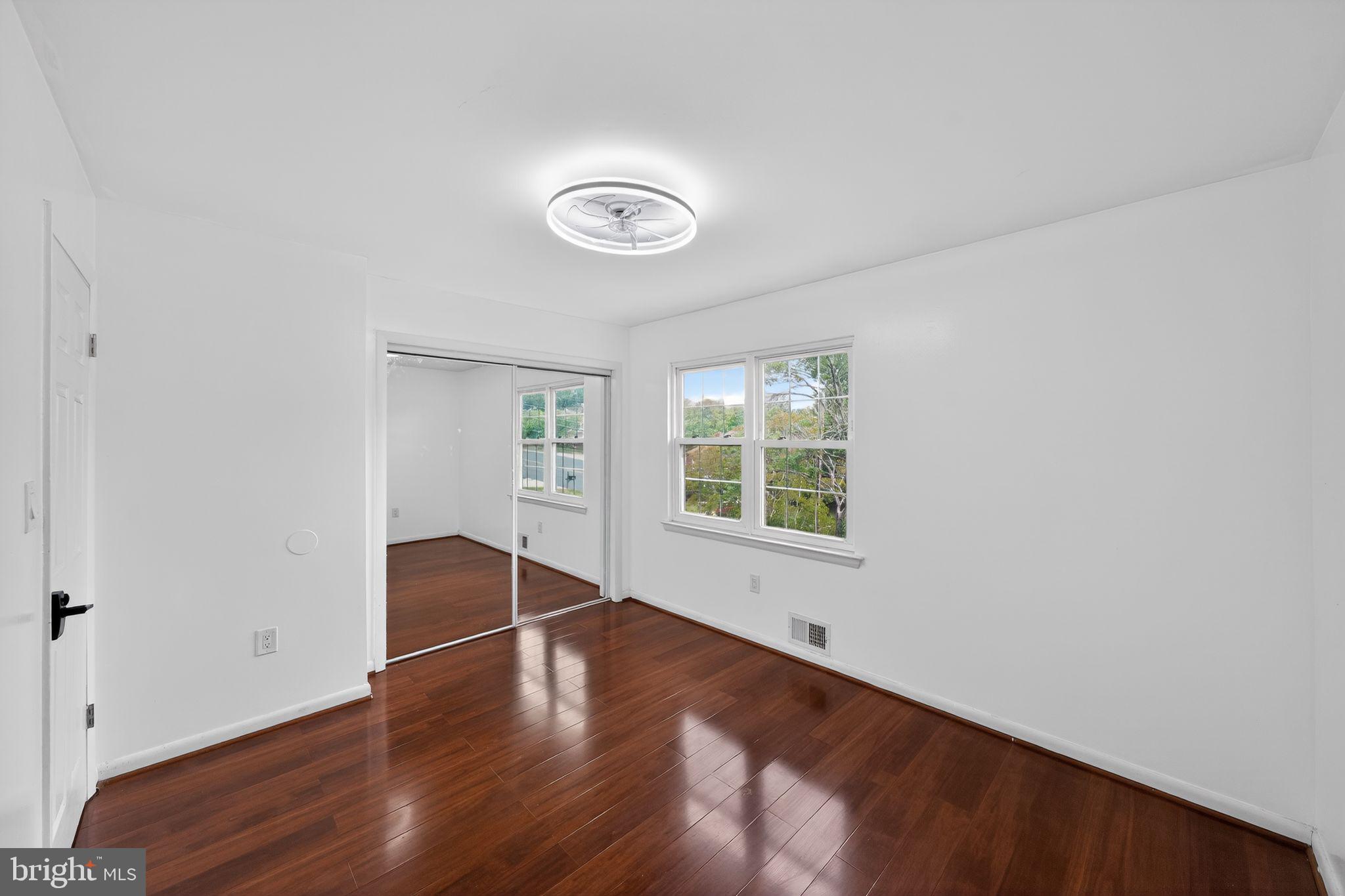 13312 Fort Washington Road Fort Washington, MD 20744 - Photo 16 of 34 an empty room with wooden floor and windows