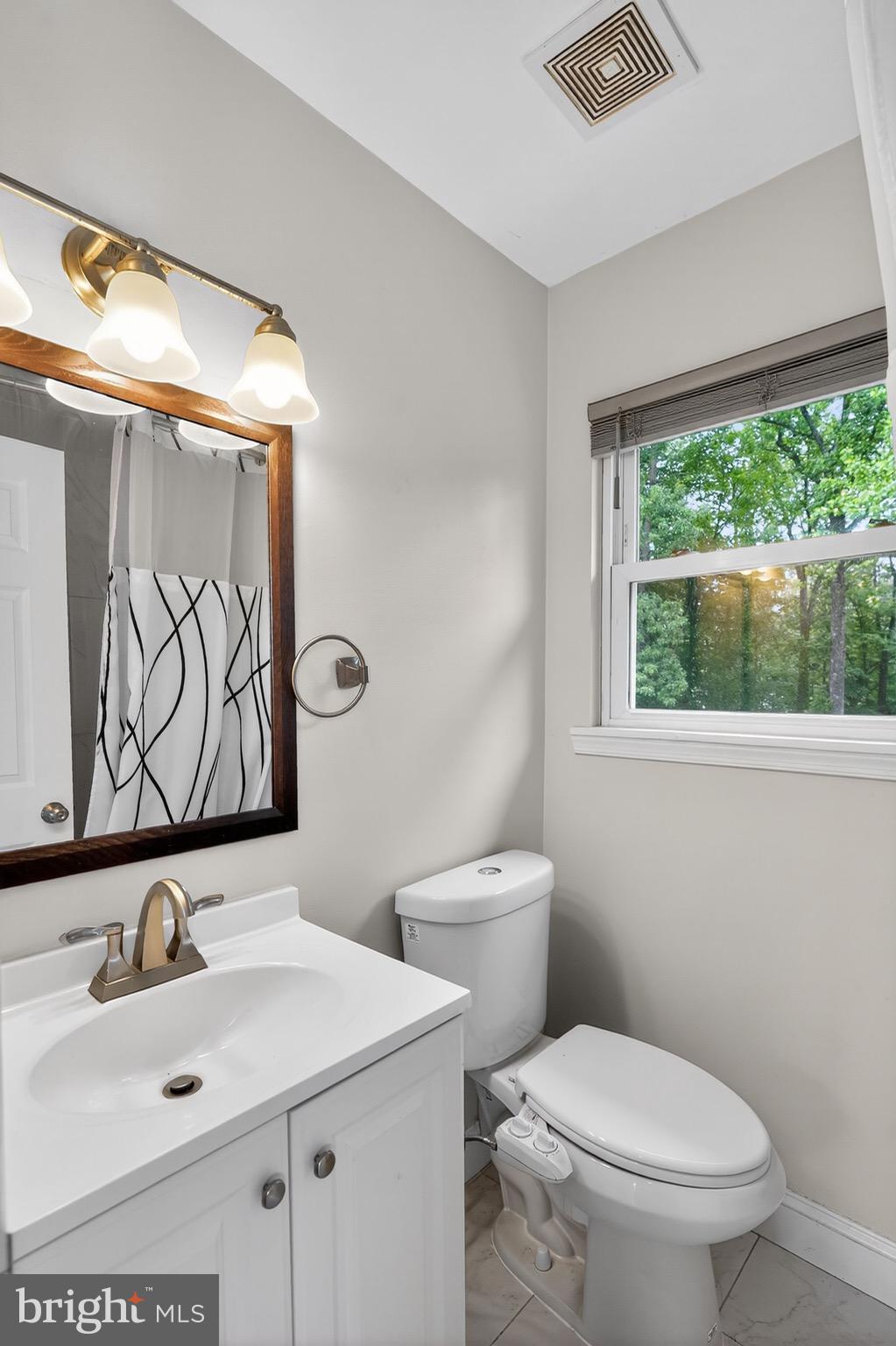 13312 Fort Washington Road Fort Washington, MD 20744 - Photo 20 of 34 a bathroom with a toilet sink and mirror