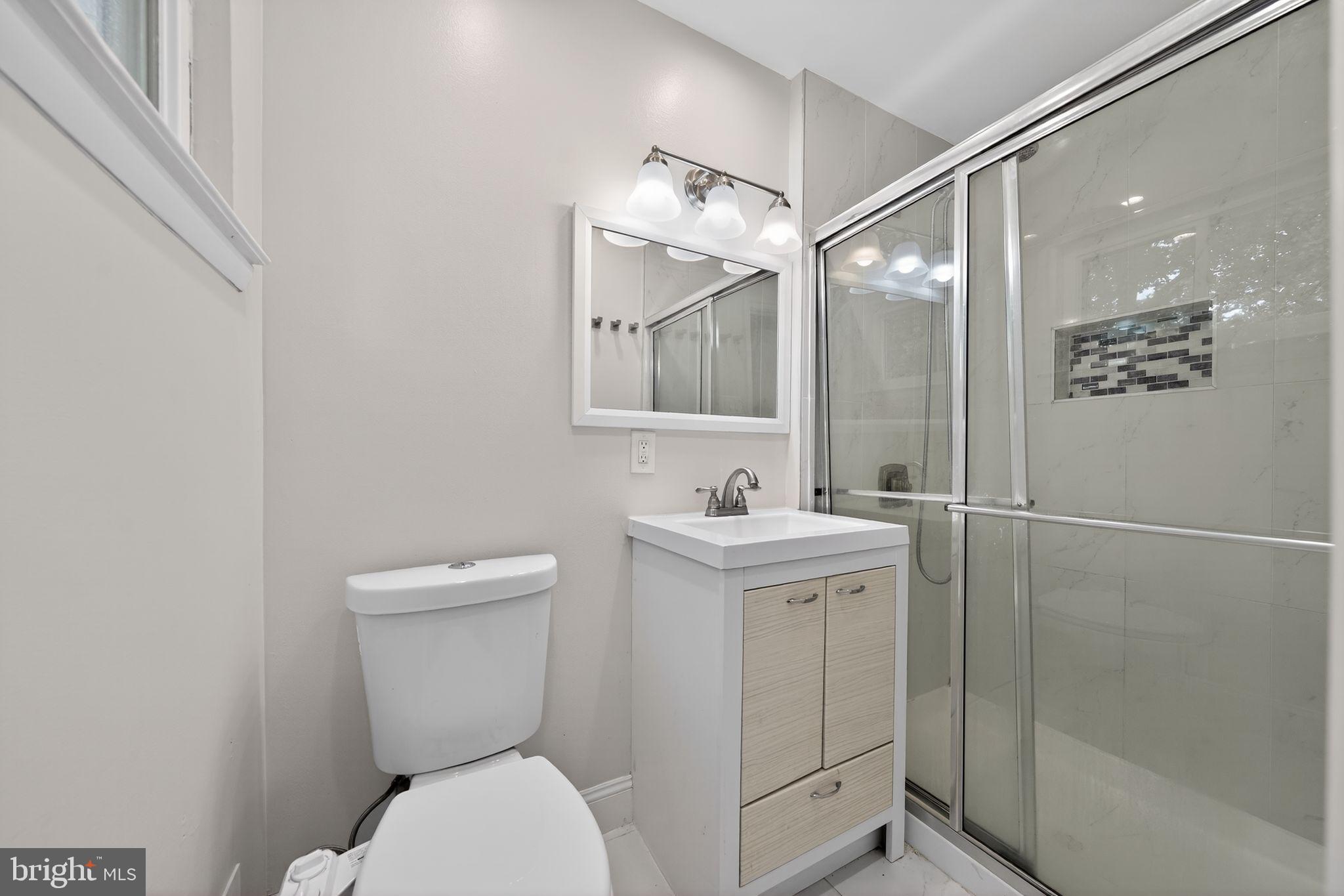 13312 Fort Washington Road Fort Washington, MD 20744 - Photo 21 of 34 a bathroom with a toilet sink and mirror