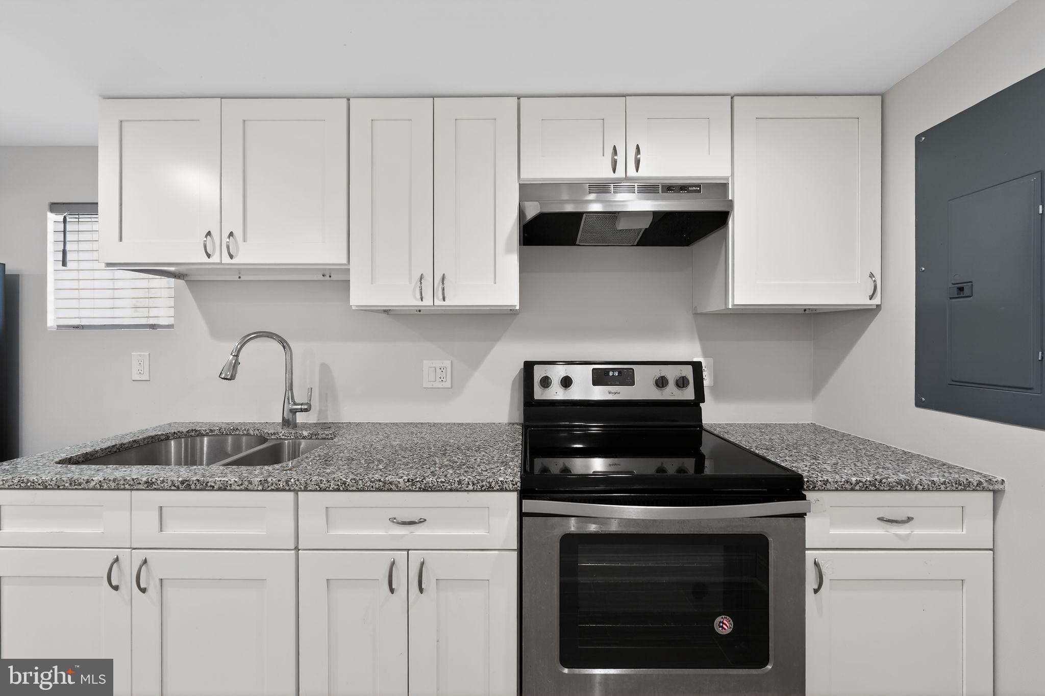 13312 Fort Washington Road Fort Washington, MD 20744 - Photo 24 of 34 a kitchen with granite countertop white cabinets and a stove