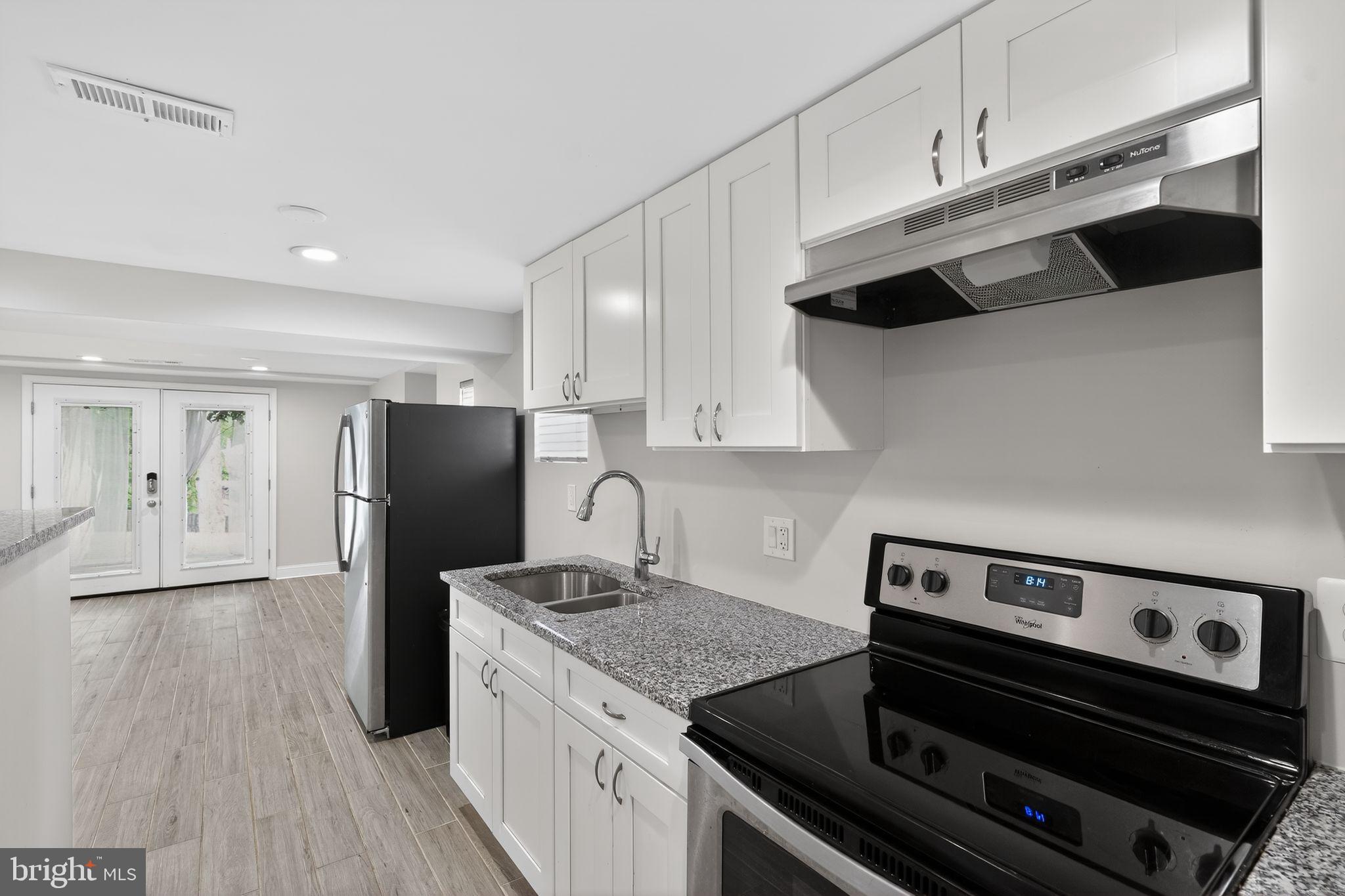 13312 Fort Washington Road Fort Washington, MD 20744 - Photo 25 of 34 a kitchen with stainless steel appliances a sink a stove and a refrigerator