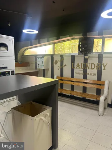 a living room with stainless steel appliances kitchen island granite countertop furniture and a large window