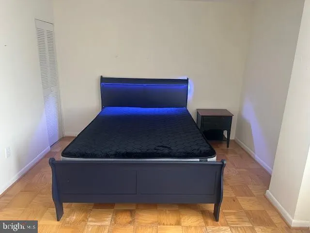 a bed sitting in a bedroom next to a wall