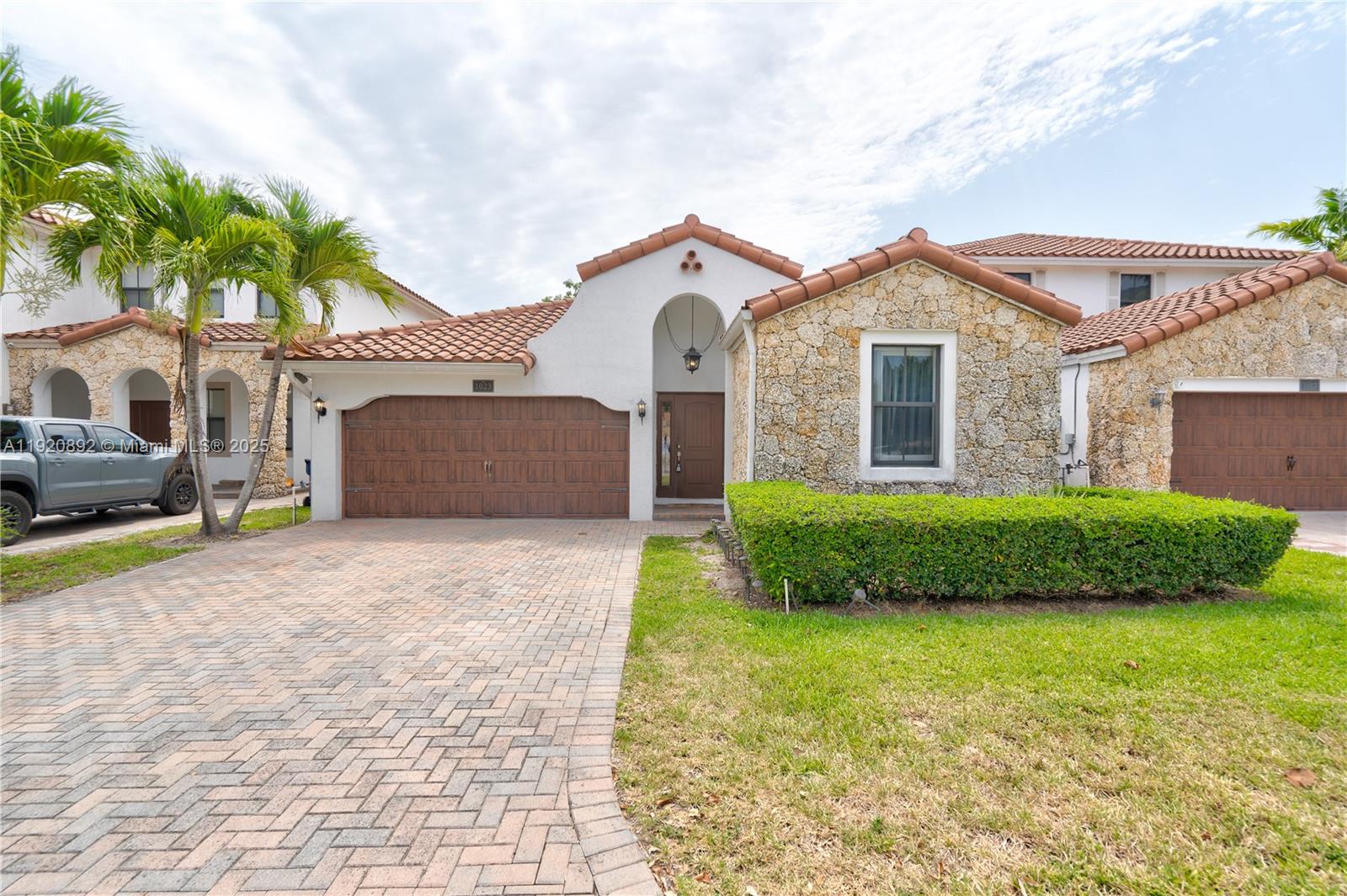 a front view of a house with a yard and garage