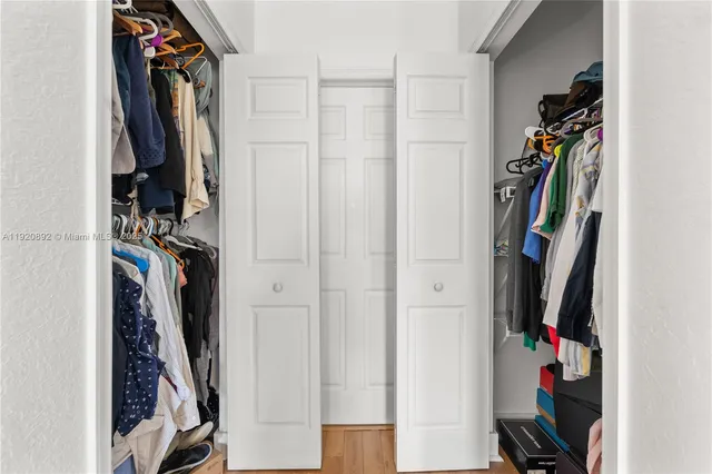 a view of walk in closet with clothes