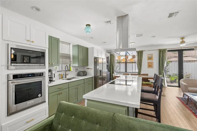 a kitchen with furniture and large windows