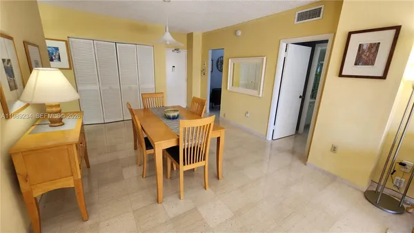 a dining room with furniture and a window
