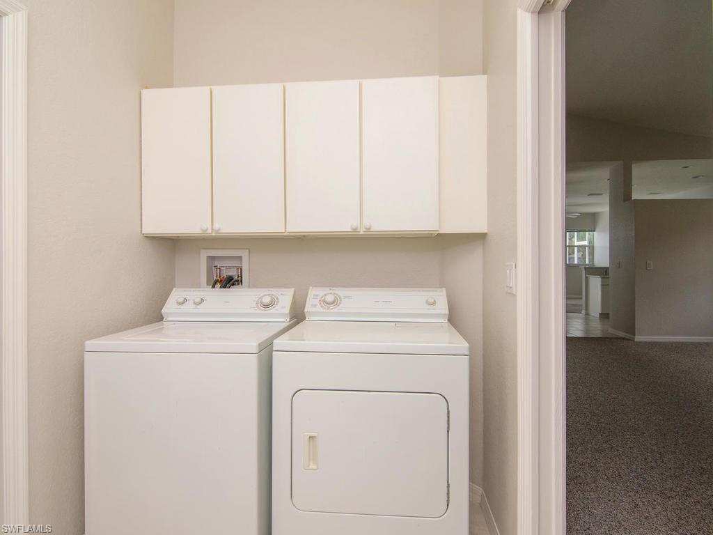 718 Crossfield Circle Naples, FL 34104 - Photo 13 of 17 a view of storage and utility room with washer and dryer