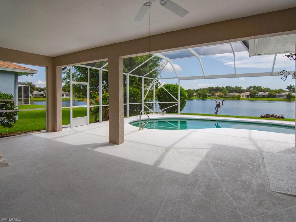 718 Crossfield Circle Naples, FL 34104 - Photo 14 of 17 a view of a house with a big yard and potted plants