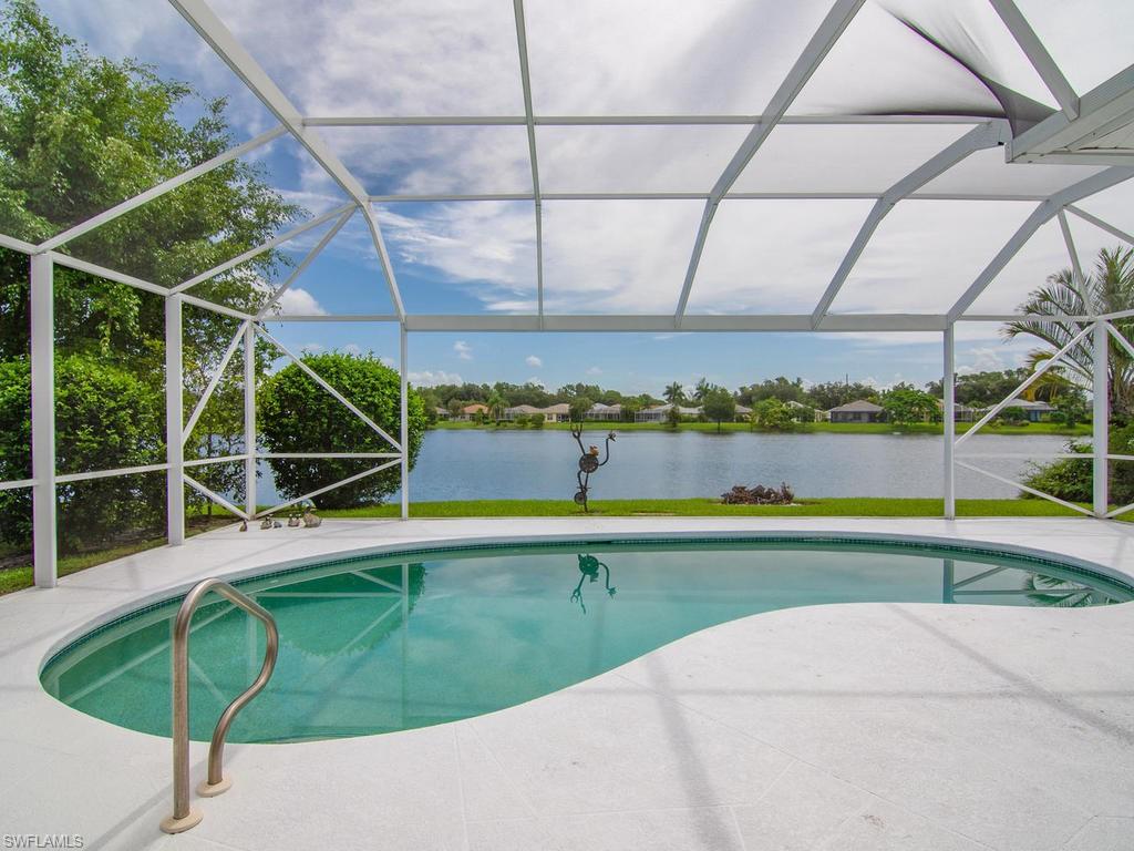 718 Crossfield Circle Naples, FL 34104 - Photo 16 of 17 a view of a swimming pool with a patio and a yard