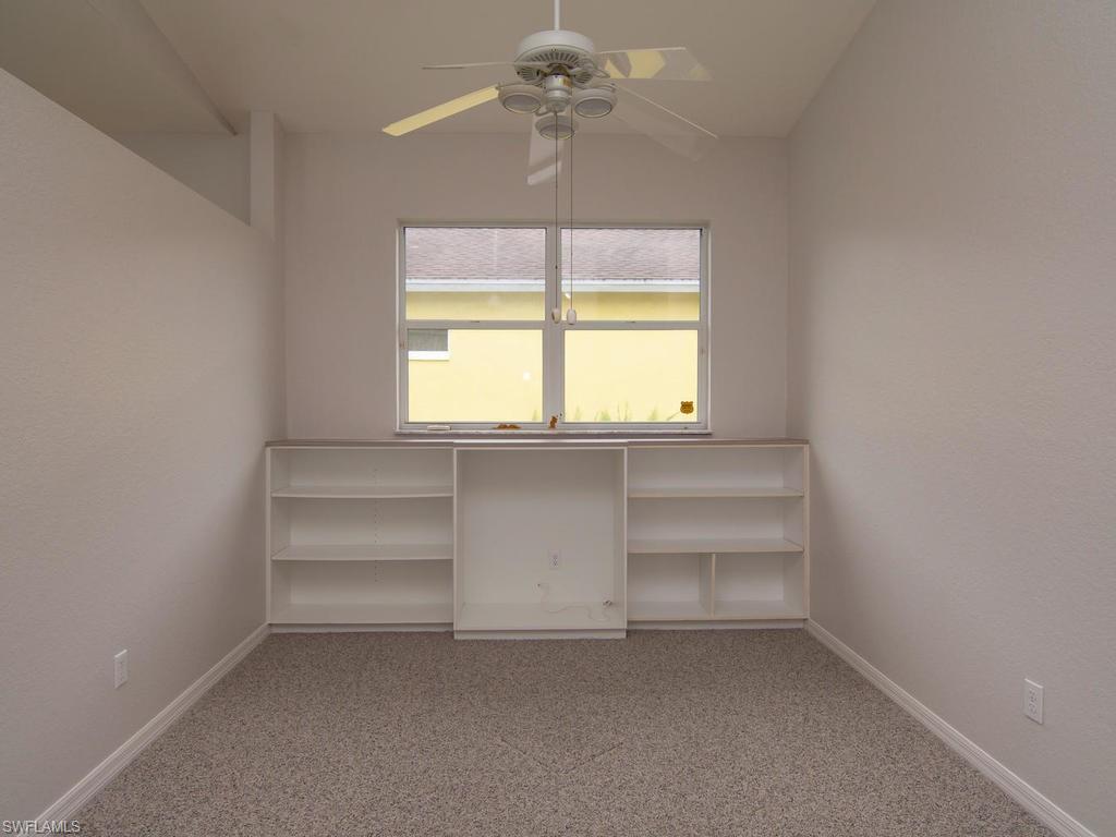 718 Crossfield Circle Naples, FL 34104 - Photo 4 of 17 an empty room with a window and a ceiling fan