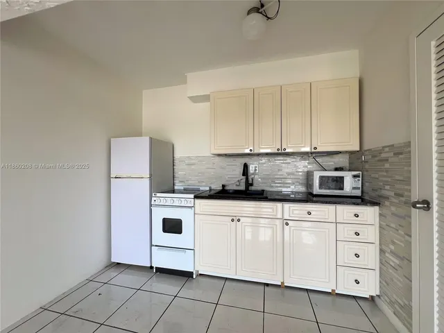 a kitchen with cabinets stainless steel appliances and sink