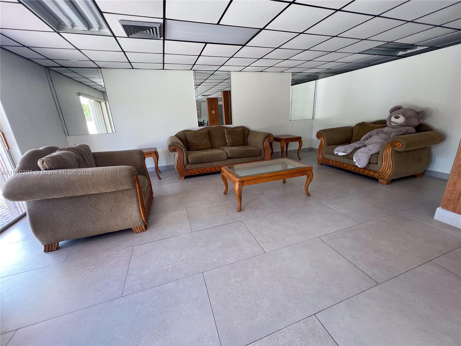 2200 East Hallandale Beach Boulevard, Unit 603 Hallandale Beach, FL 33009 - Photo 14 of 17 a living room with furniture and a chandelier