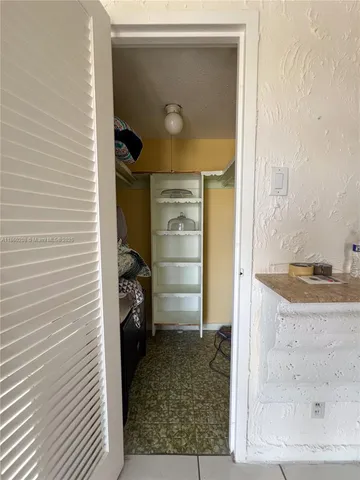a view of a livingroom with kitchen and furniture