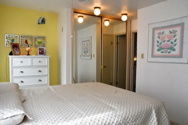 a bedroom with a bed and a window