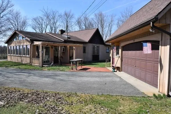 a front view of a house with basket ball court and garage