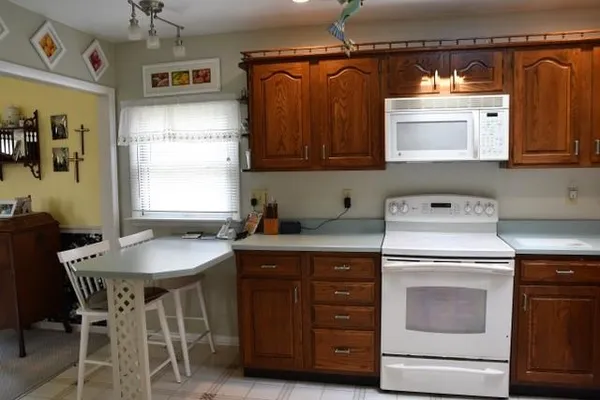 a kitchen with a stove a sink and a microwave