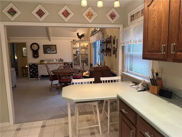 a kitchen with a sink a stove and chairs