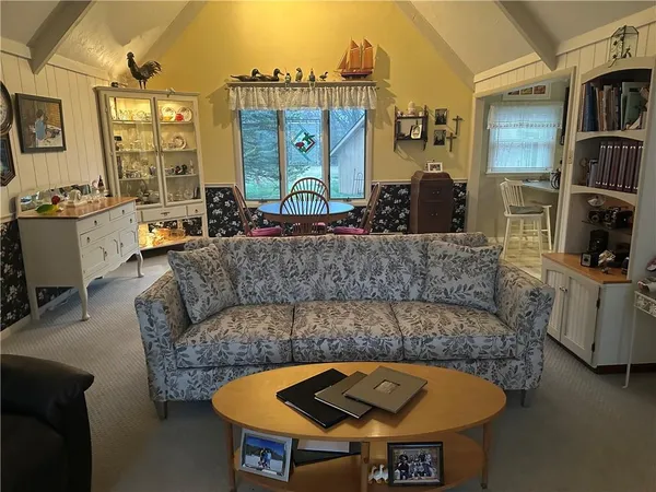 a living room with furniture and a floor to ceiling window