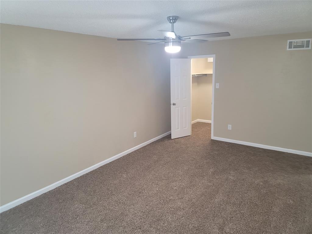 4616 Country Creek Drive, Unit 1176 Dallas, TX 75236 - Photo 13 of 19 an empty room with a chandelier fan and a ceiling fan
