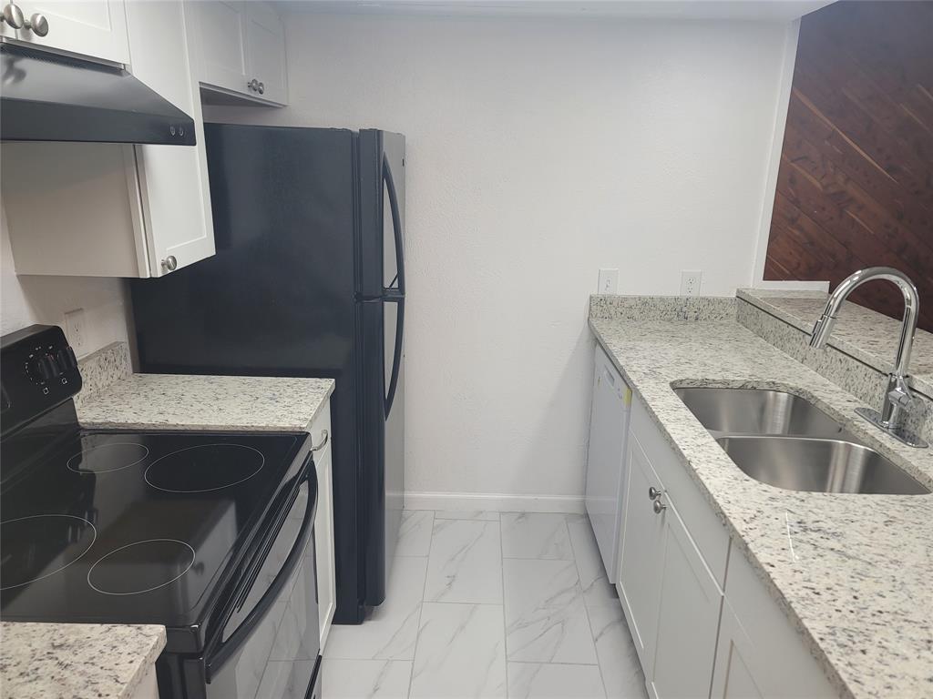 4616 Country Creek Drive, Unit 1176 Dallas, TX 75236 - Photo 2 of 19 a kitchen with a sink and a refrigerator
