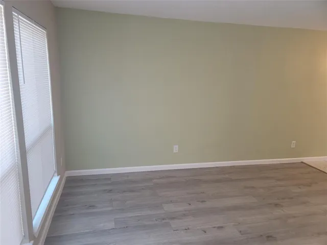 a view of an empty room and wooden floor