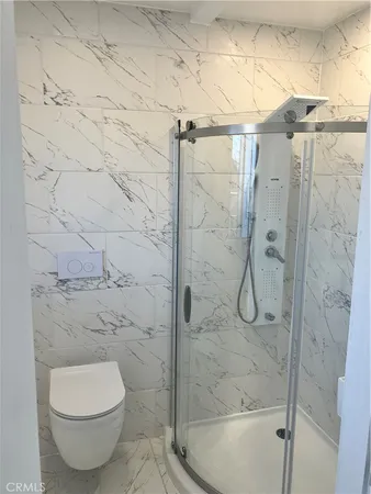 a bathroom with a toilet and a shower
