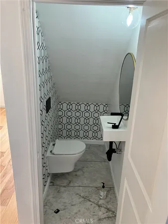 a bathroom with a granite countertop toilet and a shower
