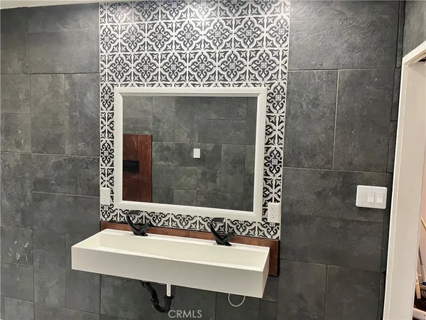 a bathroom with a sink mirror and shower