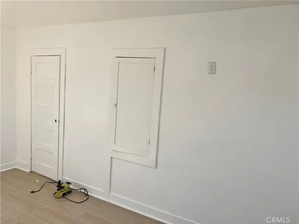a room with gym equipment and a glass door shower